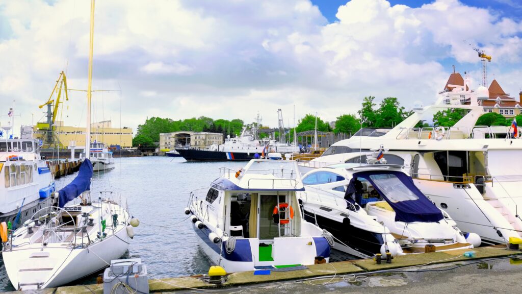 Luxury yachts and boats docked at a waterfront marina
